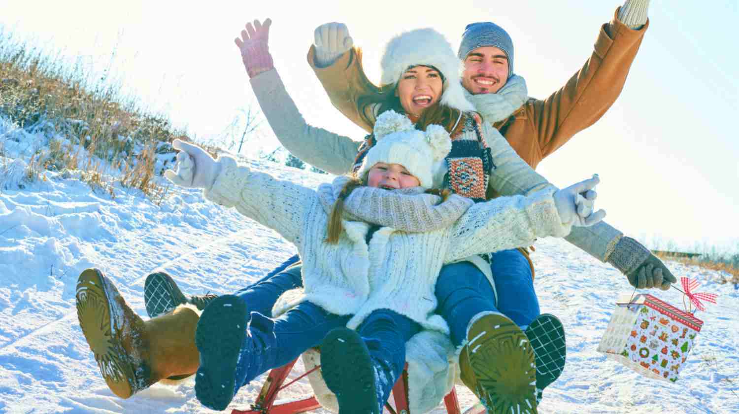 Feature | family having fun on sled | Playdate Ideas To Try This Winter | playdate app