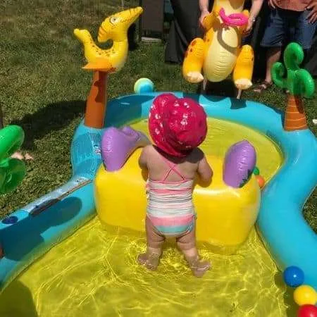 Baby in a inflatable pool. Outdoor activities for a 1 year old. 
