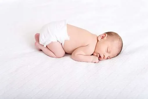 baby sleeping with knees under